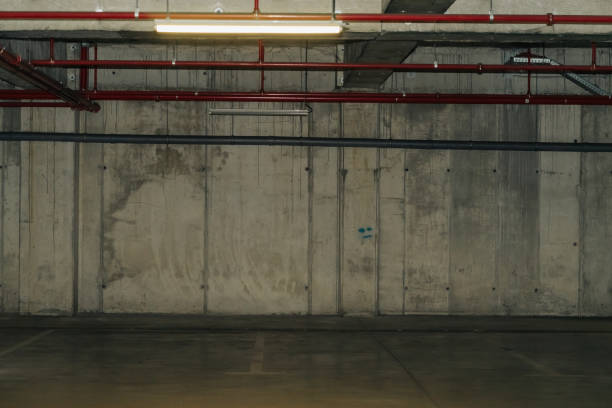 istock Parking lot with overhead dim light, underground parking garage 2166734048