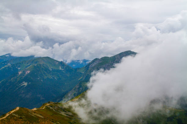 Beautiful mountain landscape with clouds and fog.