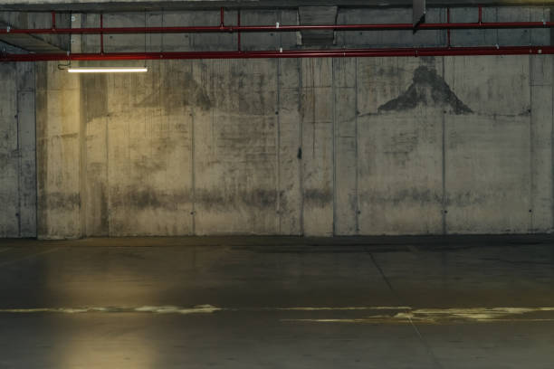 istock Parking lot with overhead dim light, underground parking garage 2166734169