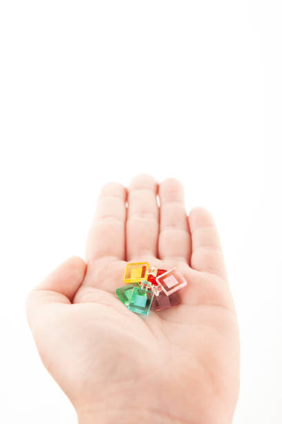 istock image of miniature glass bottle hand white background 2166735482