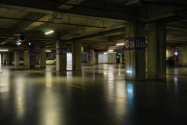 istock Parking lot with overhead dim light, underground parking garage 2166736281
