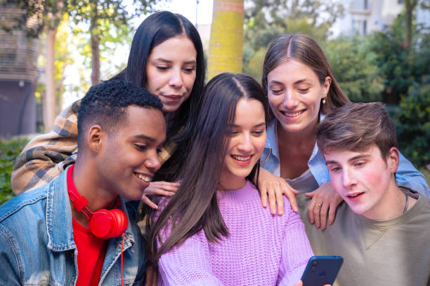 istock Five students having fun with mobile phones creating content on social media. 2166736343