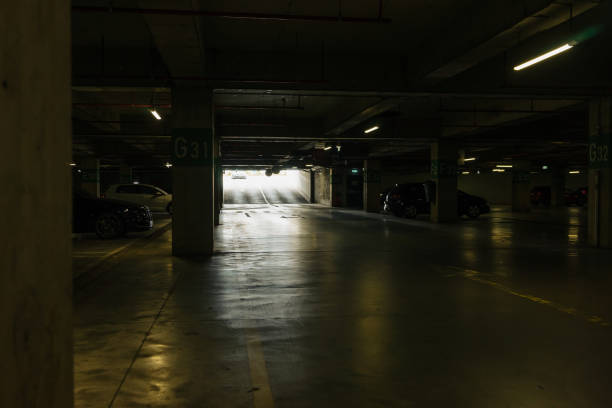istock Parking lot with overhead dim light, underground parking garage 2166736402
