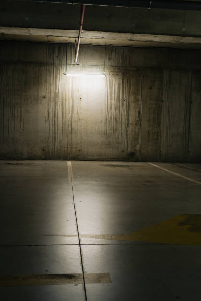istock Parking lot with overhead dim light, underground parking garage 2166736517