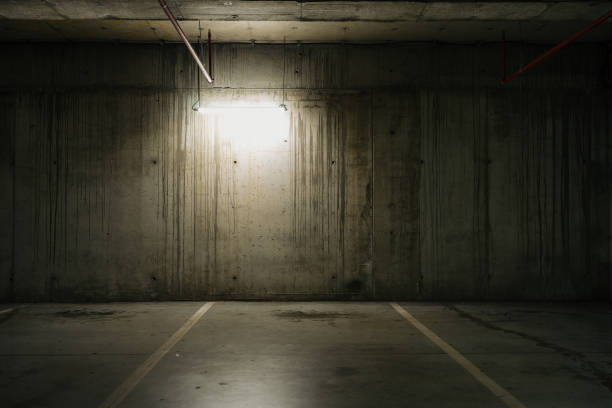 istock Parking lot with overhead dim light, underground parking garage 2166736742