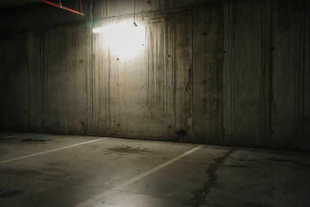 istock Parking lot with overhead dim light, underground parking garage 2166736926