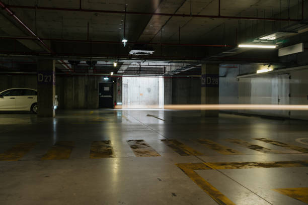 istock Parking lot with overhead dim light, underground parking garage 2166737078