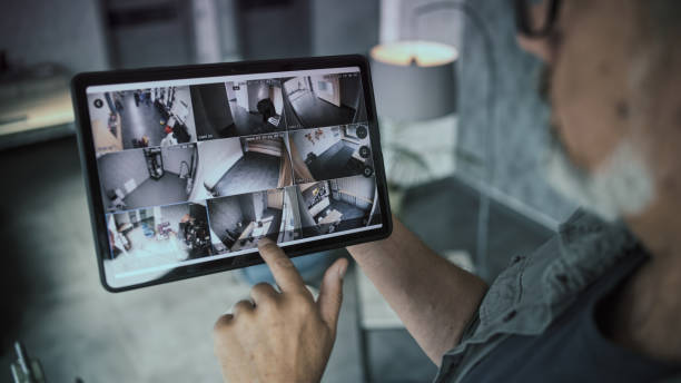 istock Professional installer watches security cameras in stylish office using tablet computer 2166739463