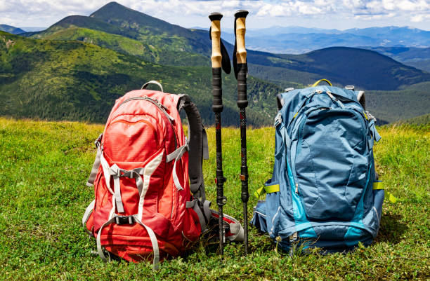 Hiking in the mountains with two backpacks in the summer.