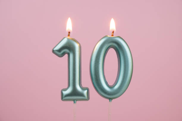 istock Blue birthday candles on pink background, number 10 2166741091