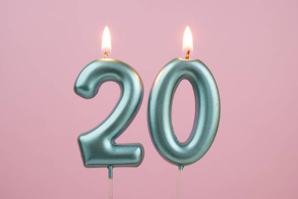 istock Blue birthday candles on pink background, number 20 2166741097