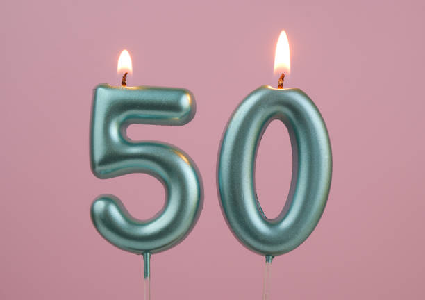 istock Blue birthday candles on pink background, number 50 2166741101