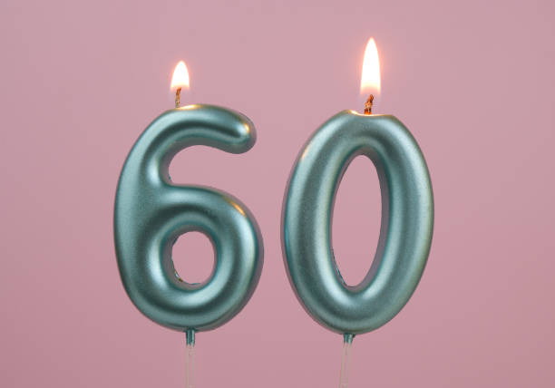 istock Blue birthday candles on pink background, number 60 2166741119