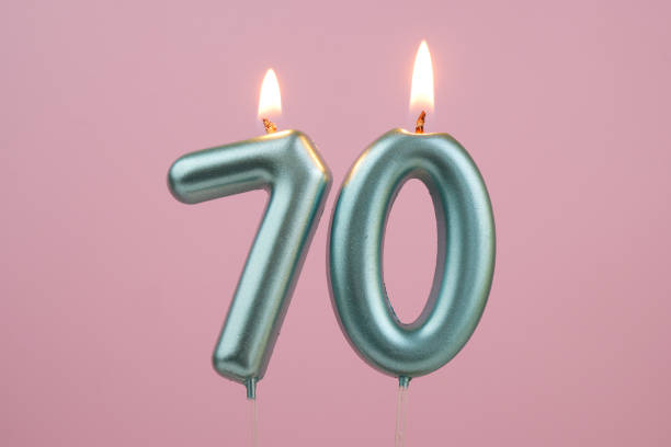 istock Blue birthday candles on pink background, number 70 2166741122