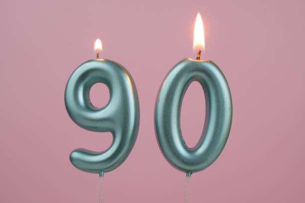 istock Blue birthday candles on pink background, number 90 2166741136