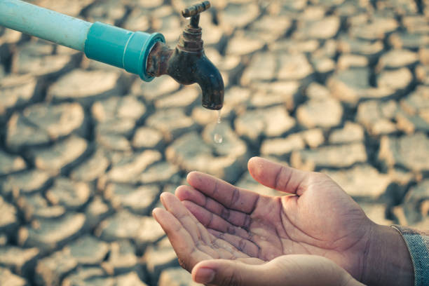 istock Hand for drinking water to live through drought, Concept drought and crisis environment. 2166741394