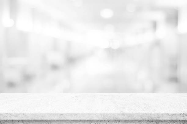 istock Empty white table top, counter, desk background over blur perspective bokeh light background, White concrete stone table, shelf and blurred kitchen restaurant for food, product display mockup, template 2166743373