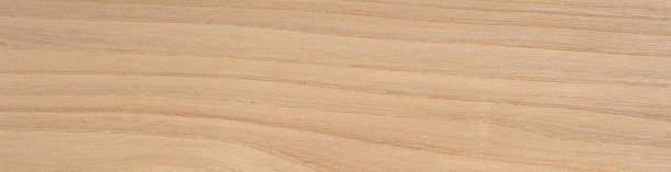 This image features the delicate grain and soft, sandy hues of a rustic elm veneer, accentuated by its natural wood knots and gentle undulating patterns