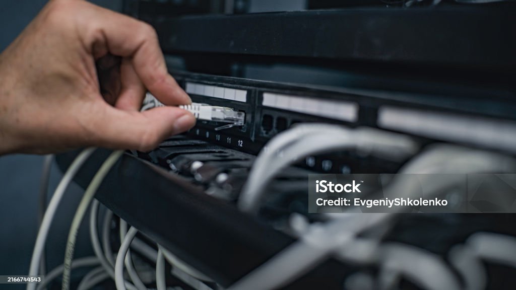 Network Server Working Male System Administrator Connects Cables With Server Rack Working In ...