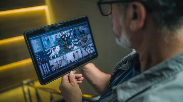 istock Male installer watches CCTV cameras in stylish office using tablet computer 2166745964