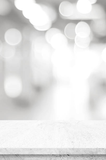 istock Empty white table top, counter, desk background over blur abstract perspective bokeh light background, White concrete stone table, shelf and blurred kitchen restaurant for food, product display mockup, template 2166746223