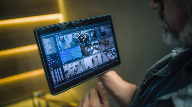 istock Male technician watches and controls surveillance cameras in modern office using tablet 2166746649