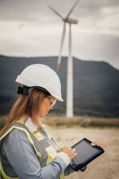 istock A skilled female engineer uses a modern tablet at a vast wind farm, highlighting the blend of advanced technology and innovative engineering in a sustainable, ecofriendly environment 2166746771