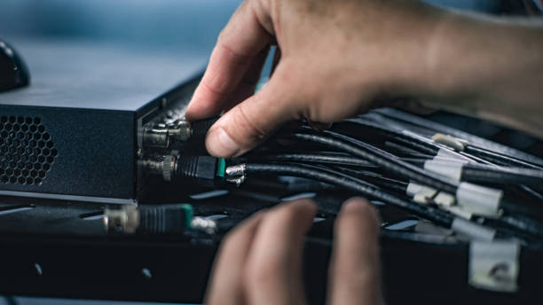istock Close up of male network administrator inserting cables into server rack 2166746805