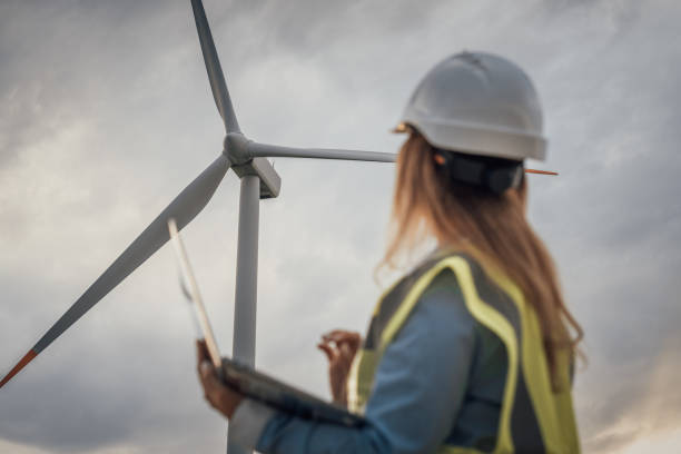istock An Engineer is thoroughly Evaluating the Performance of Wind Turbines within the broader context of a Sustainable Renewable Energy Landscape, contributing to advancements in renewable technology 2166747538