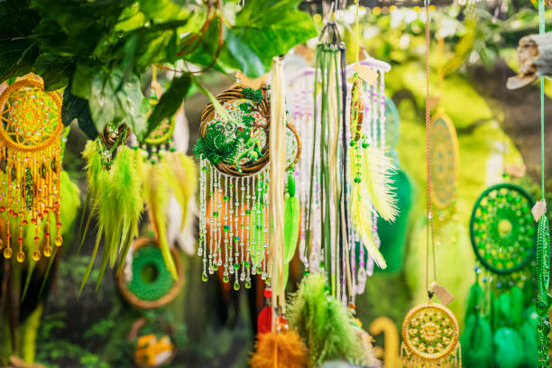Vibrant decorations with beads and feathers dangle amidst greenery. St. Patrick's Day celebrations. For background