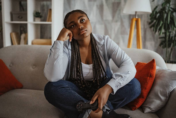istock Contemplative gamer resting on grey sofa after bad gaming session 2166748249