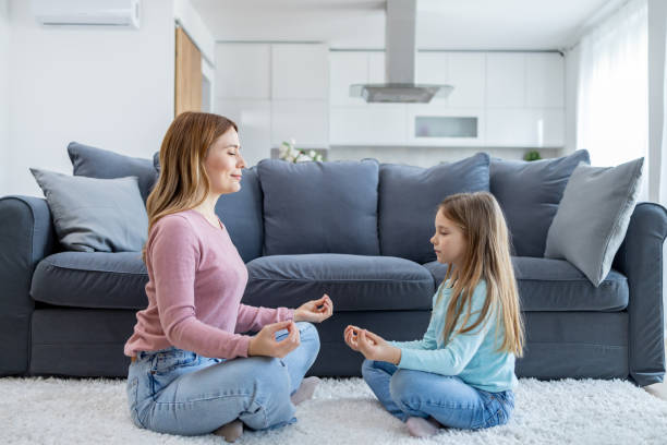 istock Mother teaching child meditation at home 2166748386