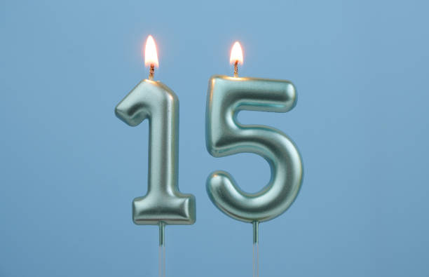 istock Blue birthday candles on blue background, number 15 2166748991