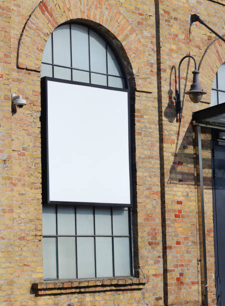istock Large white billboard banner on an office or storefront mockup. Blank white office or shop sign mock up template. 2166749139