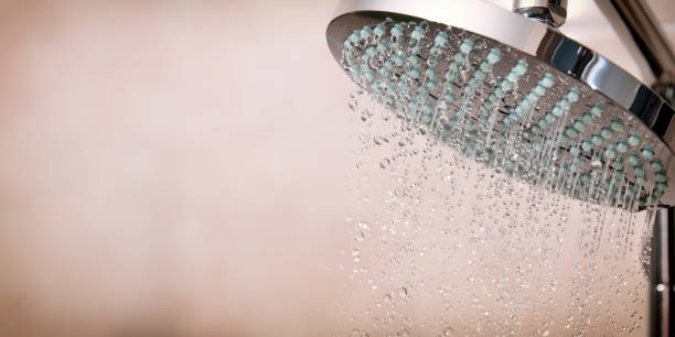 istock Modern shower head with water droplets falling from it 2166750312