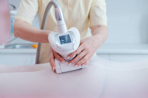 istock A woman is using a device to massage someone's body 2166750562