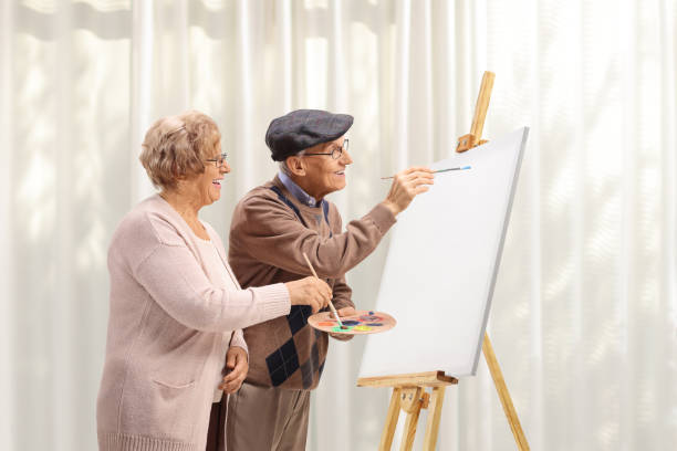 istock Elderly couple painting with brushes on a canvas 2166753341
