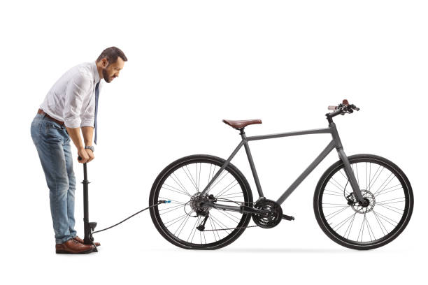 istock Businessman pumping a flat bicycle tire with a manual pump 2166753358