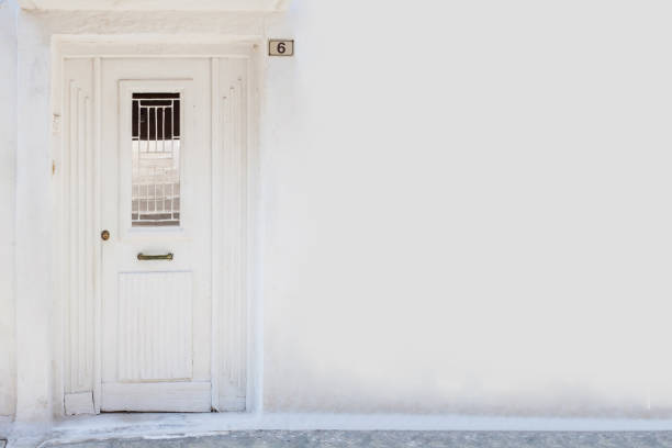 White wall background with white antique door and copy space