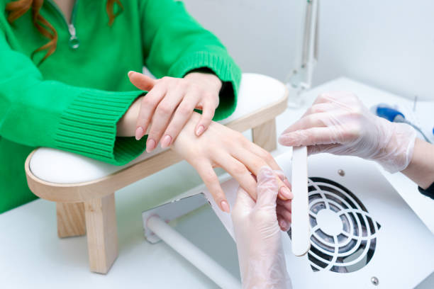 istock A woman is getting her nails done by a manicurist 2166754797