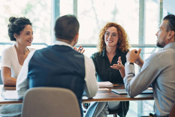 istock Business persons sitting around a table and talking 2166755768