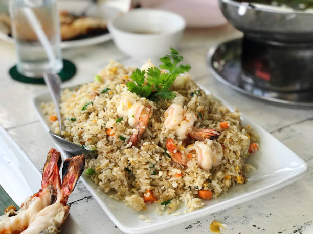 istock fried rice with prawns and vegetables on white wooden background. 2166756358