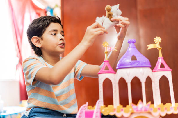 Child boy playing with castle toy at home
