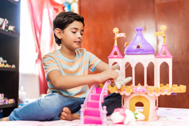 Child boy playing with castle toy at home
