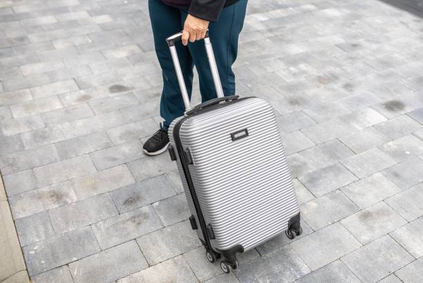 istock Unrecognizable Person Walking with a Carryon Luggage 2166760558