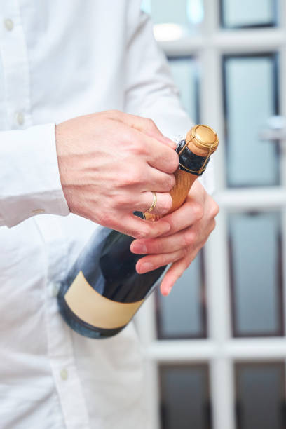 istock Men's hands open the champagne 2166761407
