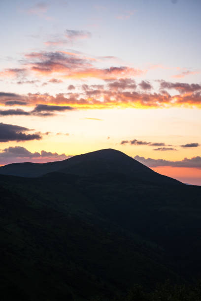 landscape in the mountains, sunset, sunrise,red, pink sky and clouds, silhouettes of peaks, Montenegrin mountain range, Carpathians, travel, screensaver, poster, poster, cover, print, spring