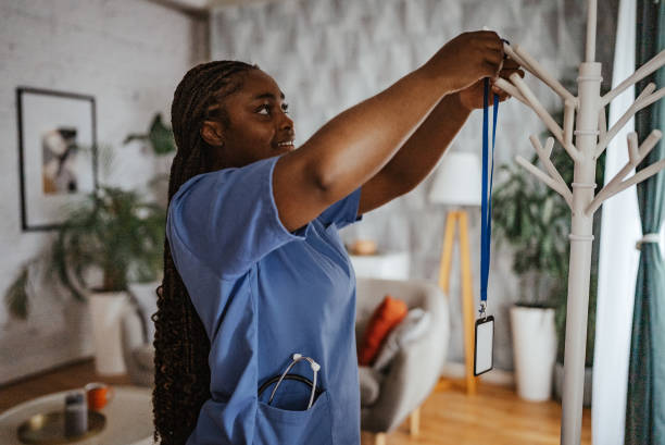istock Nurse placing badge on a coat rack in a cozy room 2166762690