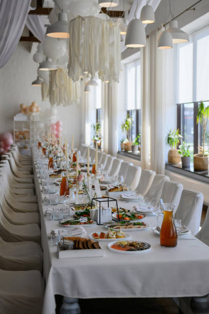 White formal chairs decorated with light brown wedding material