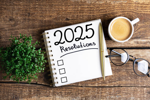 istock New year resolutions 2025 on desk. 2025 resolutions list with notebook, coffee cup on table. Goals, resolutions, plan, action, checklist concept. New Year 2025 template 2166766058